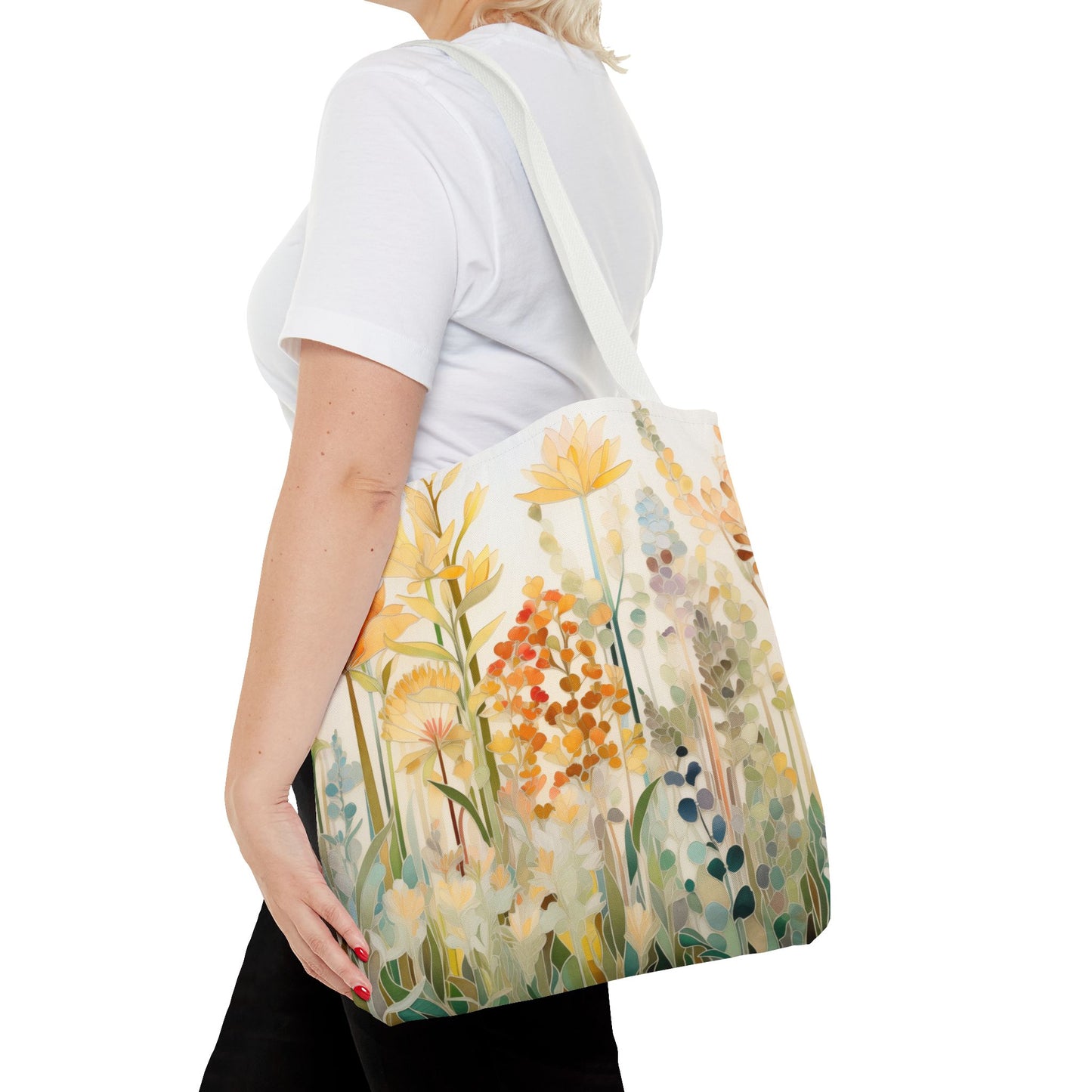 A person with blonde hair is wearing a white shirt and holding a Stained Glass Fall Flowers Tote Bag, showcasing an original artist design with a floral pattern.