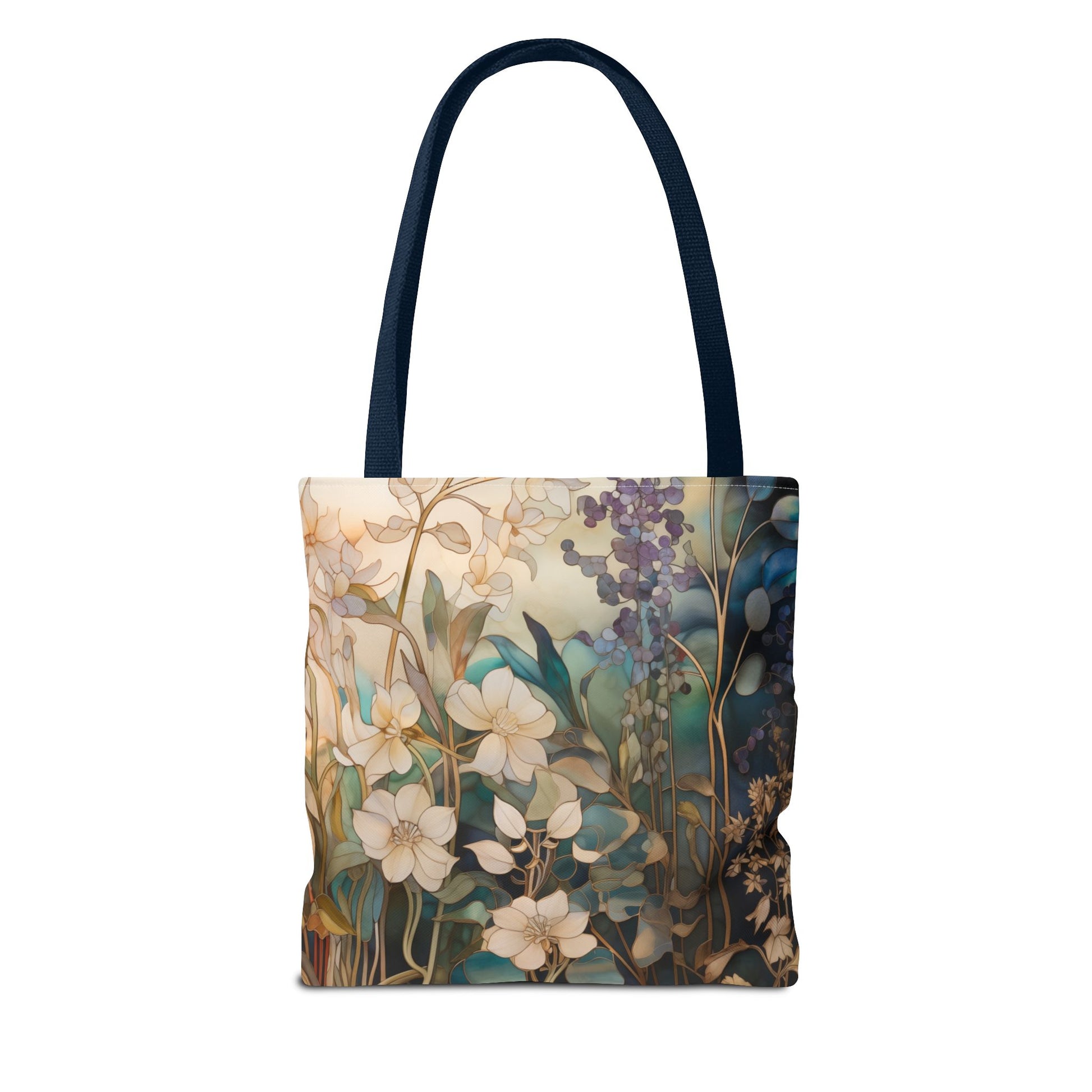 The Stained Glass Midnight Flowers Tote Bag features a floral design with white and purple flowers and green leaves on a soft, multicolored background. It has dark handles, is made from durable polyester, and is available in three sizes.