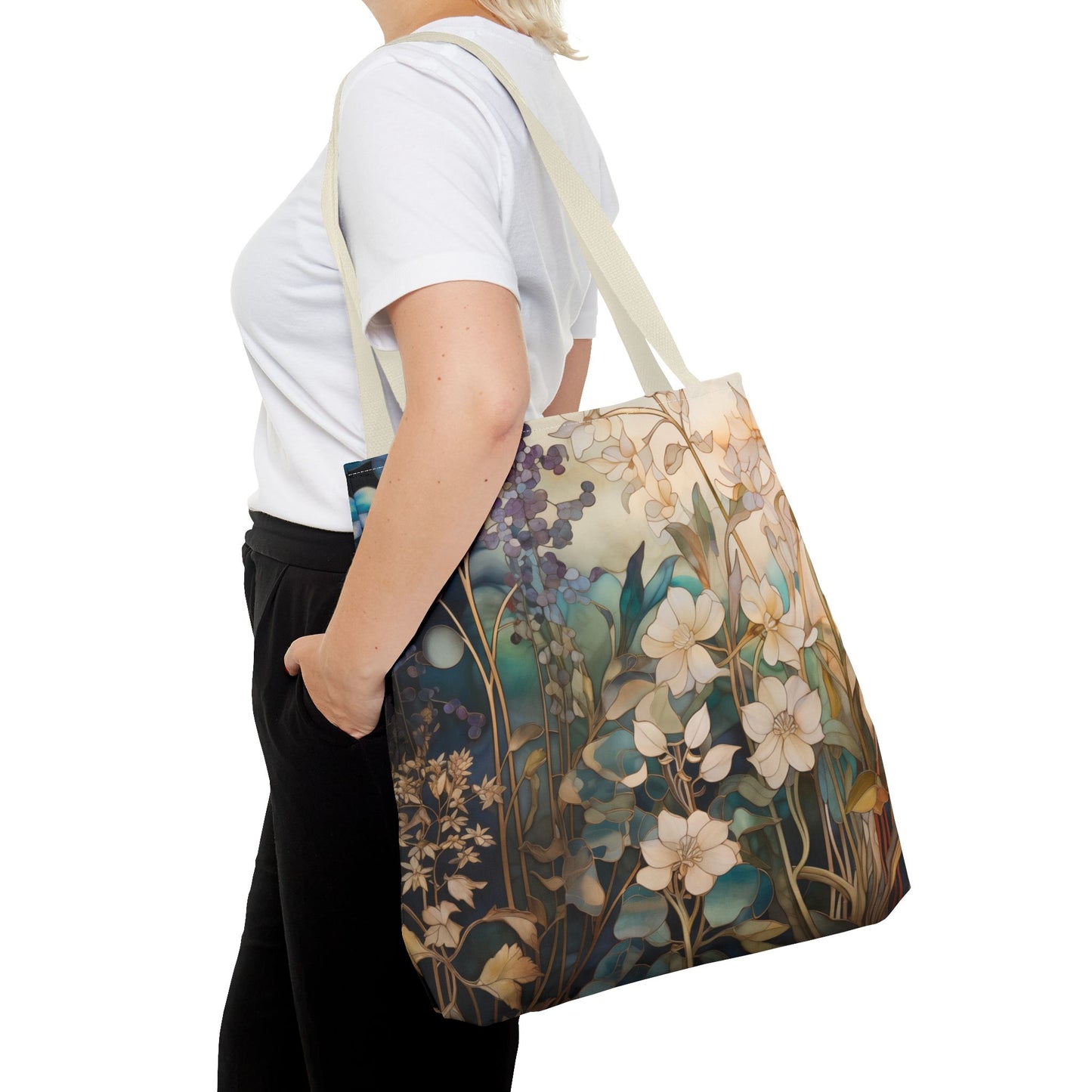 A person in a white shirt and black pants is seen from the side carrying the Stained Glass Midnight Flowers Tote Bag, which features a striking stained glass design with white and blue flowers on a muted background, crafted from durable polyester.