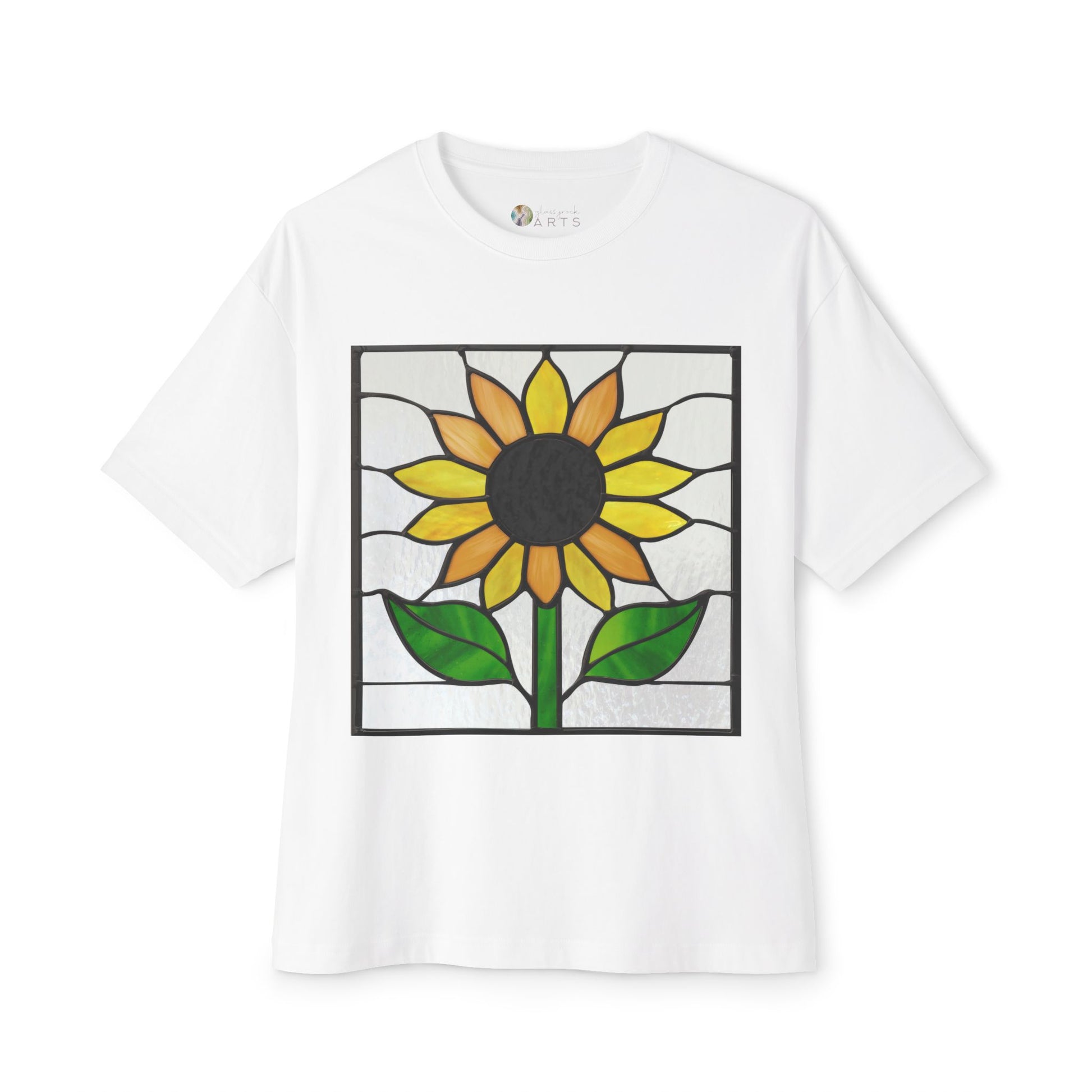 The Stained Glass Sunflower Oversized Tee Shirt by Bella+Canvas showcases an artist-designed stained glass-style sunflower with green leaves and a yellow flower with a dark center on the front, available in white.