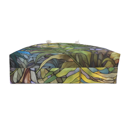 The Stained Glass Ferns Weekender Oversized Tote Bag, ideal as a boho gift, showcases a lush jungle scene with green leaves and blue-yellow accents. Its intricate design creates depth and texture, enveloping you in a vibrant forest paradise.