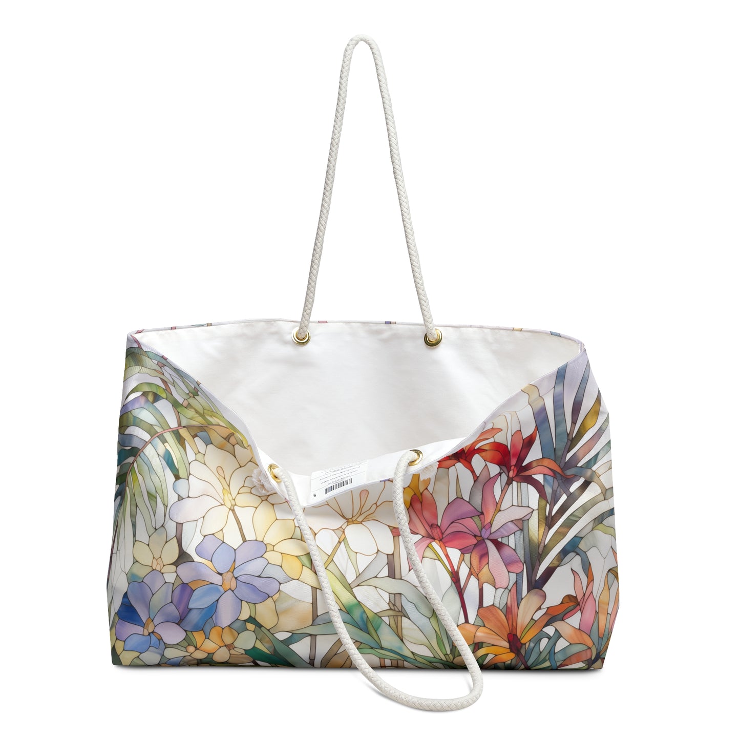 The Stained Glass Tropical Flowers Oversized Tote Bag features white rope handles and a colorful floral design with purple, yellow, and red flowers on a light backdrop. It has a white interior with visible seams and eyelet details, making it an ideal gift for any occasion.