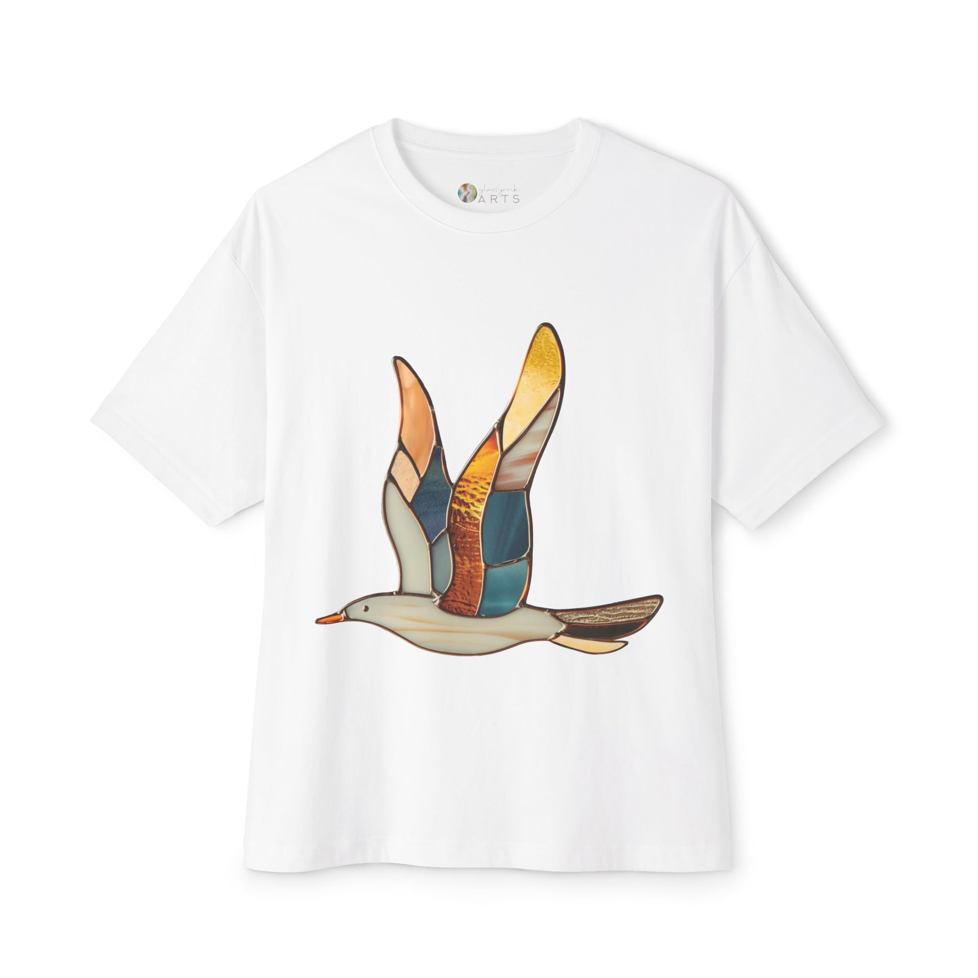 The Stained Glass Seagull Oversized Tee Shirt is crafted by Bella+Canvas for both style and eco-friendliness. This sustainable white T-shirt features a multicolored flying bird graphic on the front, reminiscent of stained glass artwork.