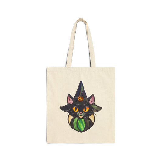 The Stained Glass Cat Witch Cotton Canvas Tote Bag showcases a cat wearing a witch's hat illustration at the center, featuring an exquisite stained glass design.