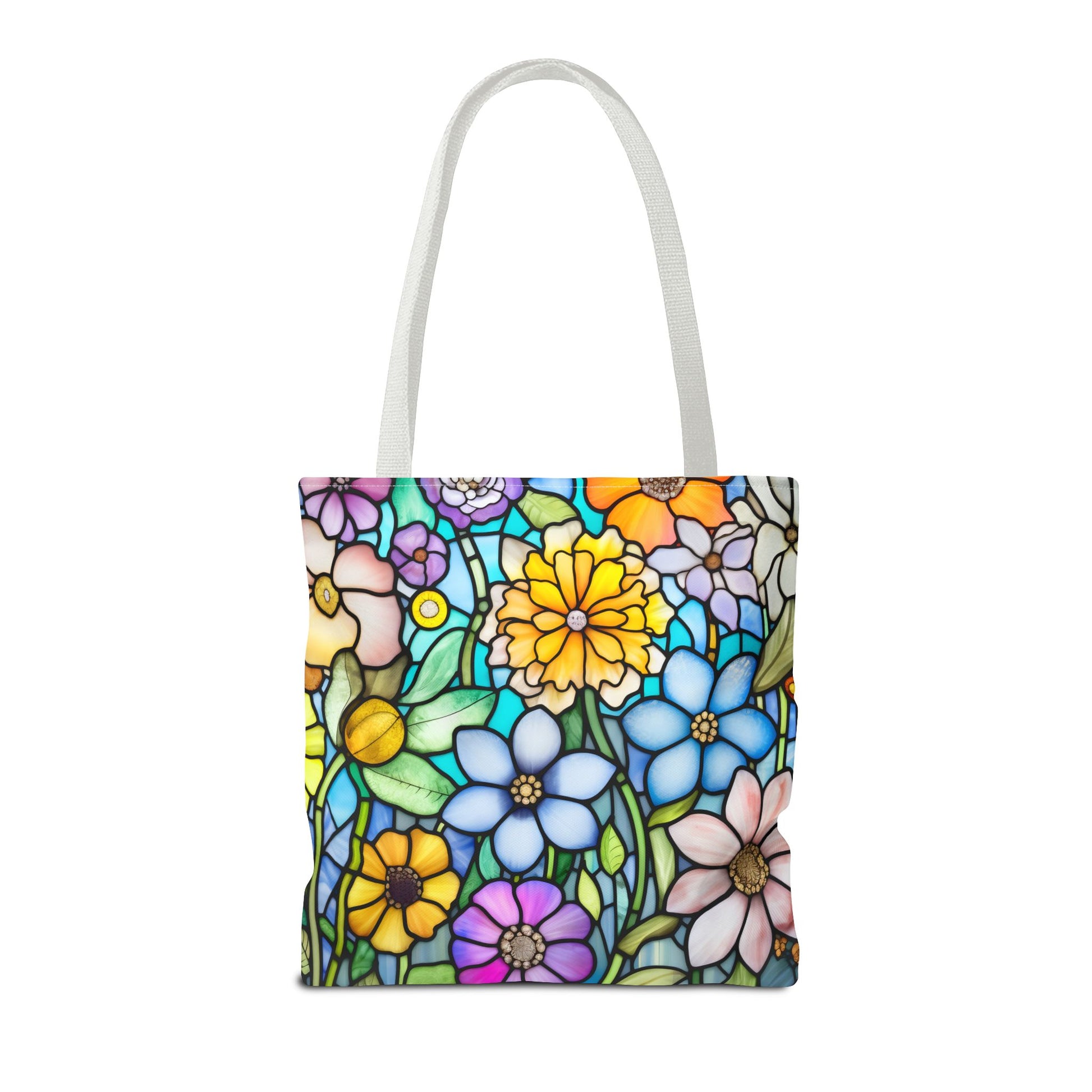 The Stained Glass Folk Art Flowers Tote Bag, available in three sizes, boasts durable polyester construction and white handles. It features a vibrant floral design with colorful blossoms and green leaves on a white background.