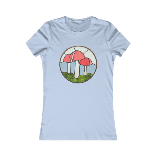 The Stained Glass Mushrooms Women's Tee Shirt by Bella+Canvas is a light blue, form-fitting t-shirt featuring a circular design of three red mushrooms and green foliage in stained glass style, made through sustainable manufacturing.