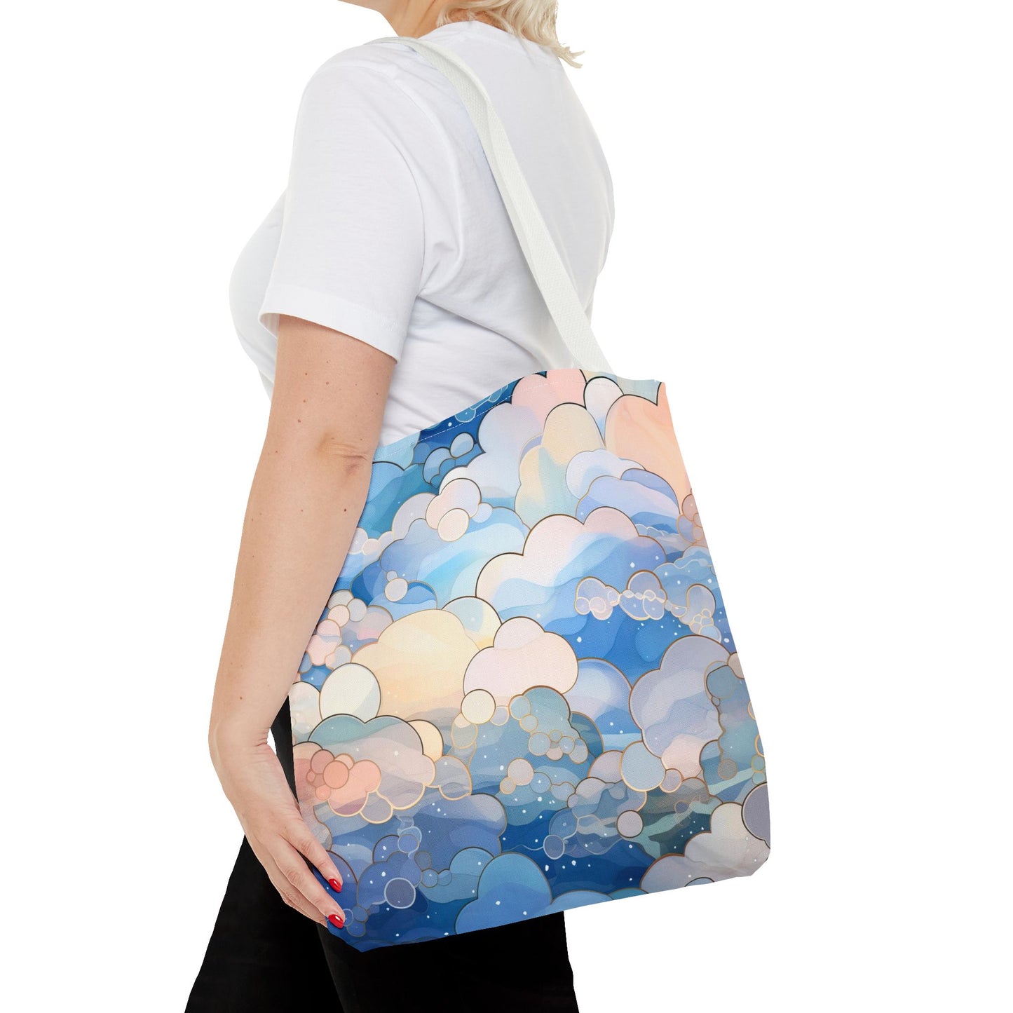 The Stained Glass Blue Clouds Tote Bag, available in 3 sizes, has handles and is crafted from durable polyester materials. It features an original artist's illustrated pattern of stained glass clouds in shades of soft blue.