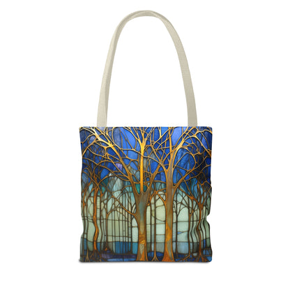 The Stained Glass Forest Tote Bag features an original design of tall trees with intricate branches on a deep blue and turquoise background. Made from durable polyester, it includes light beige handles for easy carrying. Three sizes are available.