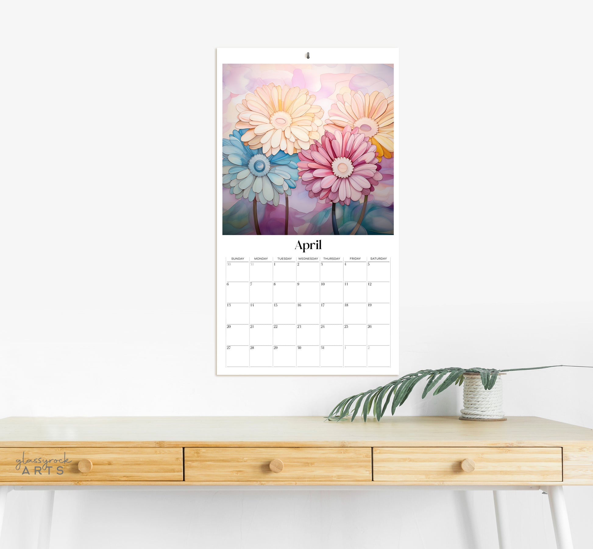 The birth flowers calendar hanging on a wall above a desk.