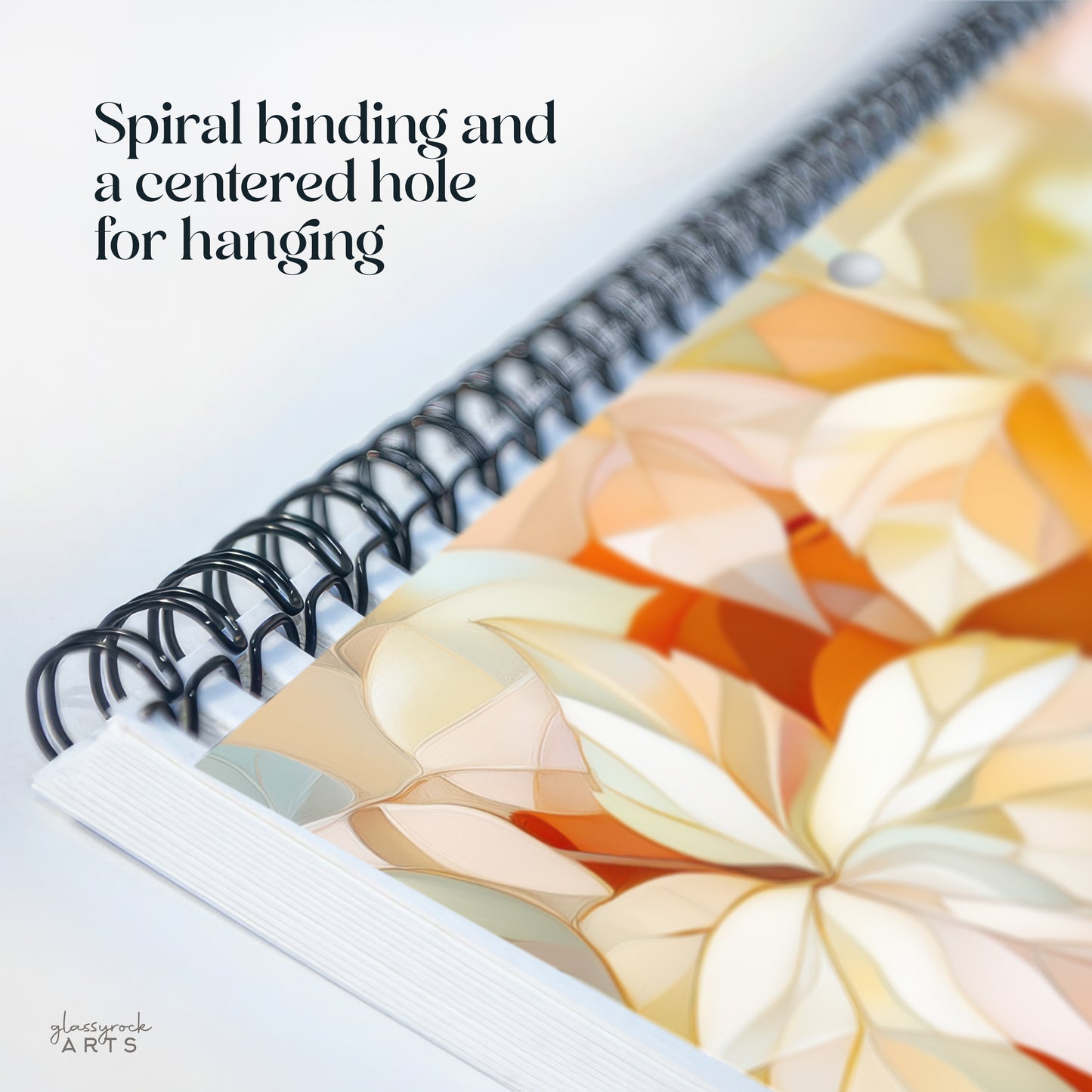 This calendar has a spiral binding and a centered hole for hanging.