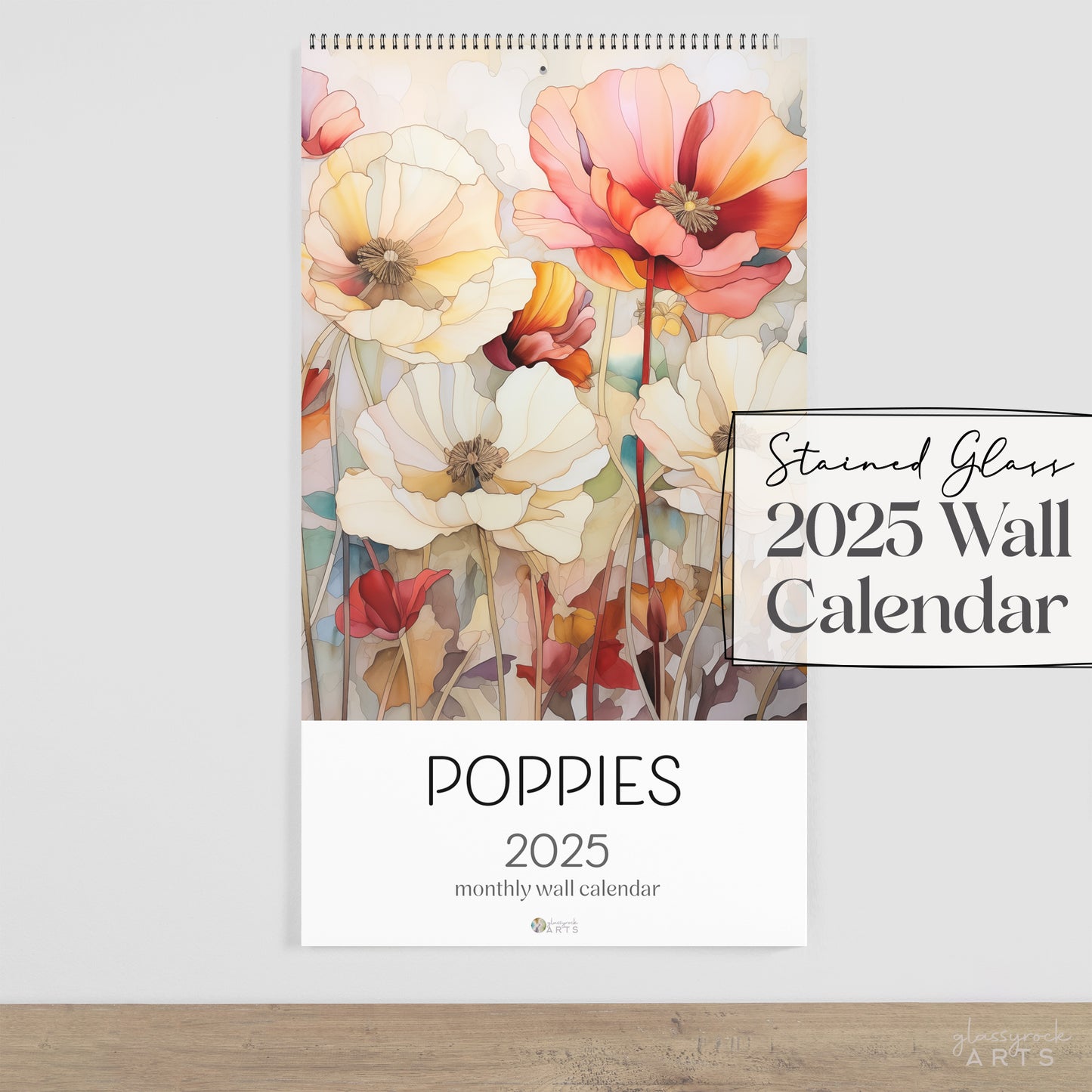 The 2025 Poppies Wall Calendar is a floral-themed art piece featuring a stained glass design of blooming poppies. Vibrant red, orange, and white flowers stand out against a neutral backdrop, making it perfect for fans of stained glass artistry.