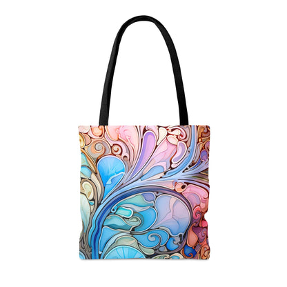 The Rainbow Paisley Stained Glass Tote Bag, available in three sizes, features black straps and showcases a vibrant, abstract multicolored design reminiscent of stained glass, with swirling patterns in blue, pink, and other colors.