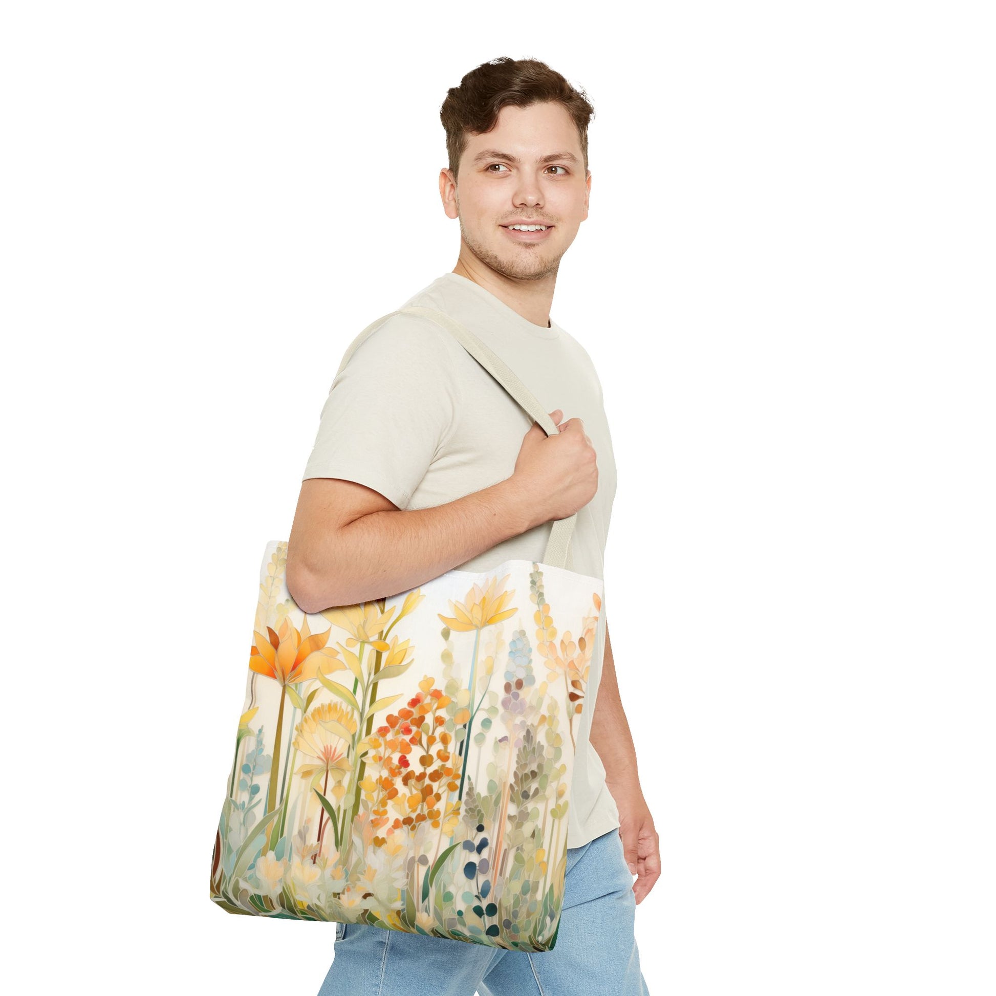 A person in a beige shirt and blue jeans smiles while carrying the Stained Glass Fall Flowers Tote Bag, featuring an artists design of colorful flowers. Made from durable polyester, it stands out against the plain white background.