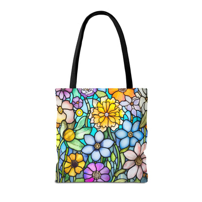 The Stained Glass Folk Art Flowers Tote Bag, available in three sizes, features a durable polyester construction with black handles and an original artist-designed colorful floral pattern reminiscent of stained glass.