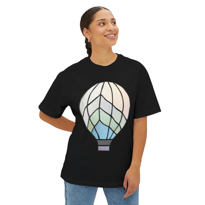 Person smiling, wearing the Stained Glass Hot Air Balloon Oversized Tee Shirt in black, with one hand on their hip.