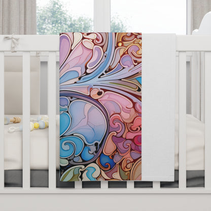 The Stained Glass Rainbow Baby Blanket, featuring a rainbow paisley print in pink, blue, and brown, drapes over a white crib. Soft light filters through a window in the background with toys visible on the cribs bedding.