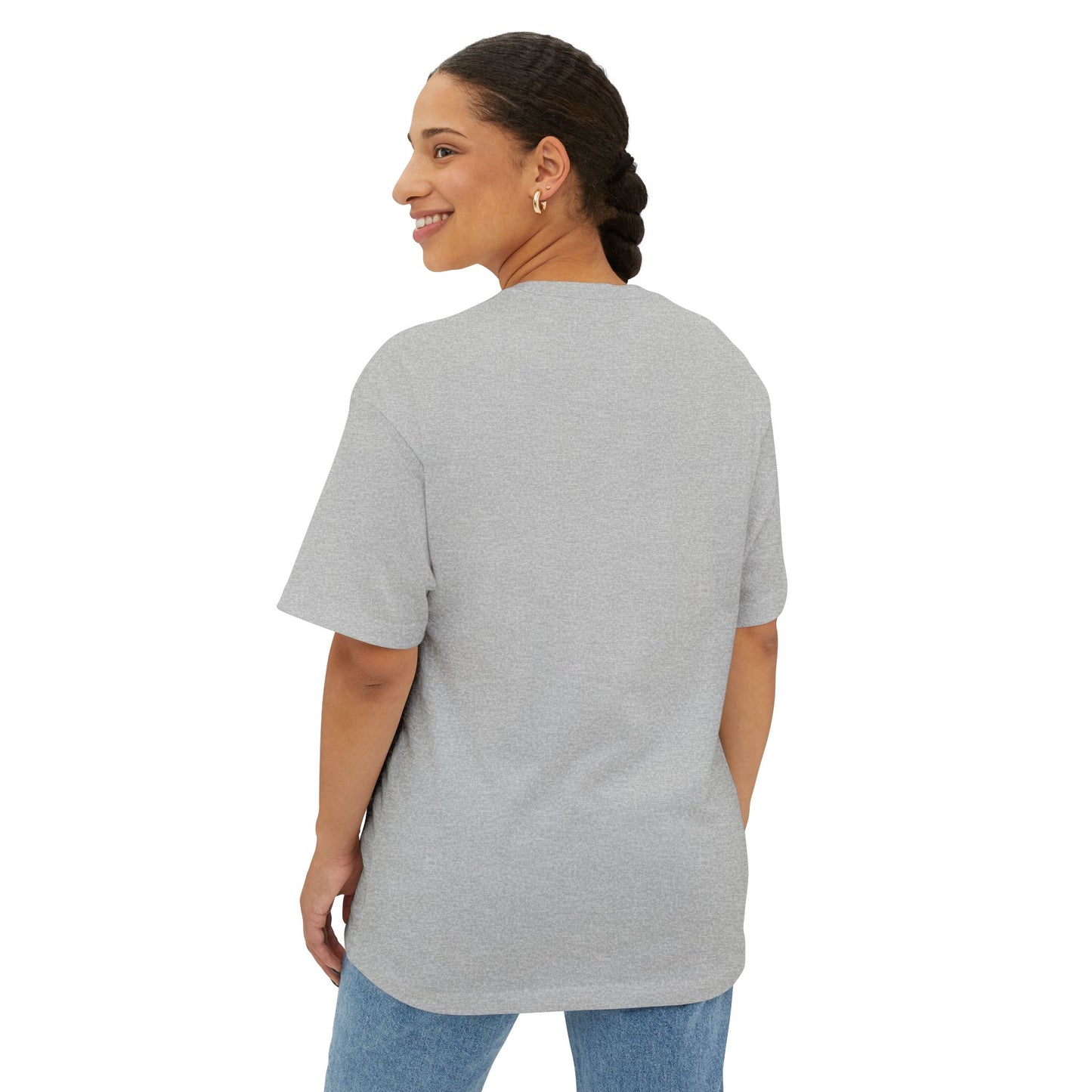 A person with braided hair, wearing a Stained Glass Turtle Oversized Tee Shirt and jeans, is smiling and looking towards their left while standing against a white background.