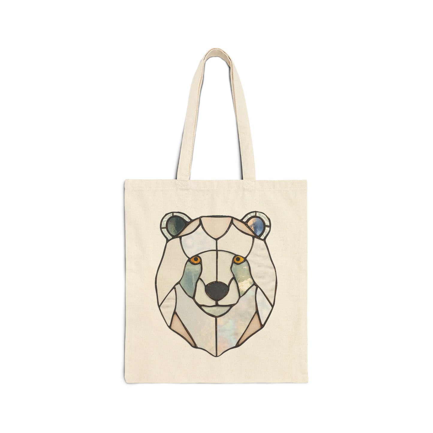 The beige Stained Glass Polar Bear Cotton Canvas Tote Bag, designed by Noelle Barnes, showcases an abstract geometric bear face in brown, gray, and black with amber eyes. Its long handles and striking design stand out beautifully against the plain white background.