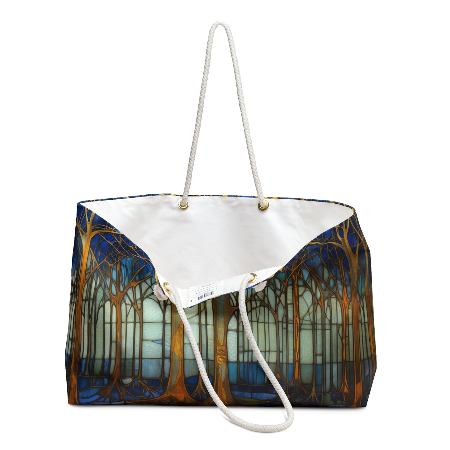 The Stained Glass Art Deco Forest Oversized Tote Bag, Blue, showcases tall tree trunks on shades of blue and brown. It has sturdy rope handles and a crisp white interior, ideal for carrying essentials.