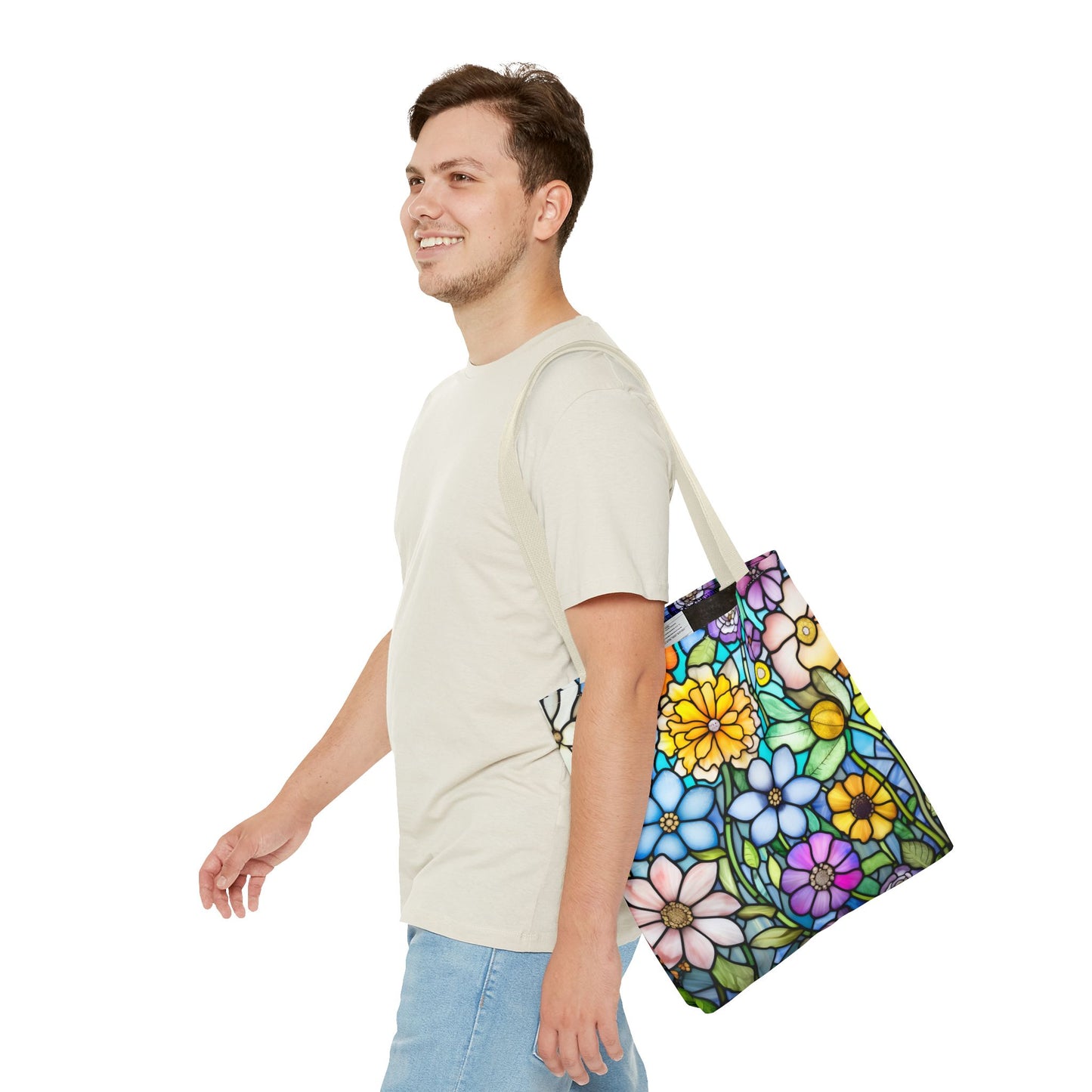 A person in a light shirt and jeans walks while carrying the Stained Glass Folk Art Flowers Tote Bag, featuring an original artist design, over their shoulder and smiles against a white background.