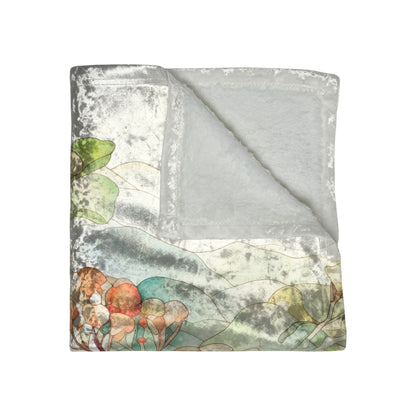 A folded Stained Glass Tropical Forest Crushed Velvet and Soft Fleece Blanket, 50x60, with a corner turned to reveal its plush interior. The top side features an abstract floral design in muted shades of green, orange, and gray.