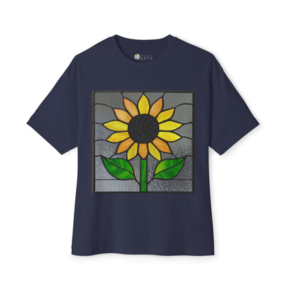 The Stained Glass Sunflower Oversized Tee Shirt by Bella+Canvas, in navy blue, boasts a striking stained glass design showcasing a sunflower with yellow petals, green leaves, and a black center.