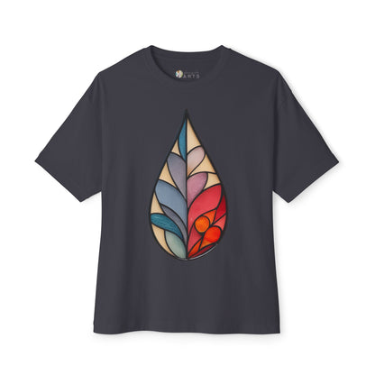 A dark gray Bella+Canvas Stained Glass Botanical Raindrop Oversized Tee Shirt featuring a colorful, abstract design resembling a tear drop shape on the front.