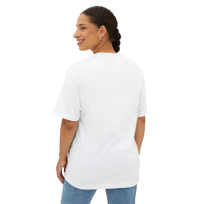 A woman with braided hair is seen from the back, wearing a Stained Glass Botanical Raindrop Oversized Tee Shirt and blue jeans.