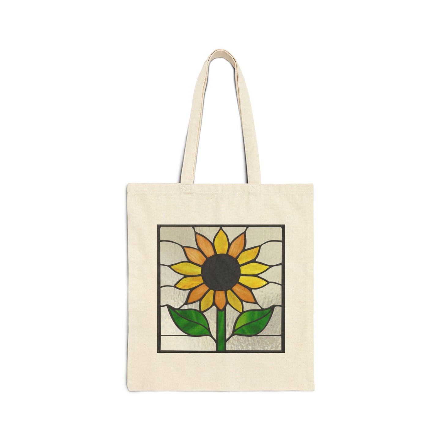 A beige cotton canvas tote bag features a unique stained glass sunflower design with yellow petals, a dark center, and green leaves against a light textured background.