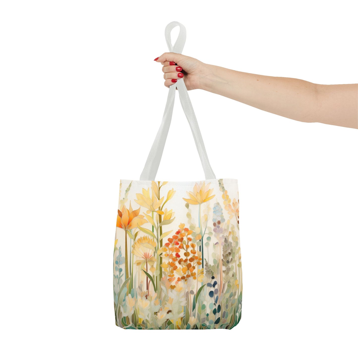 A person's hand holds the Stained Glass Fall Flowers Tote Bag with white handles, showcasing a floral design in orange, yellow, and green hues against a plain white background. This original artist-designed bag is crafted from durable polyester materials, ensuring both style and sturdiness.