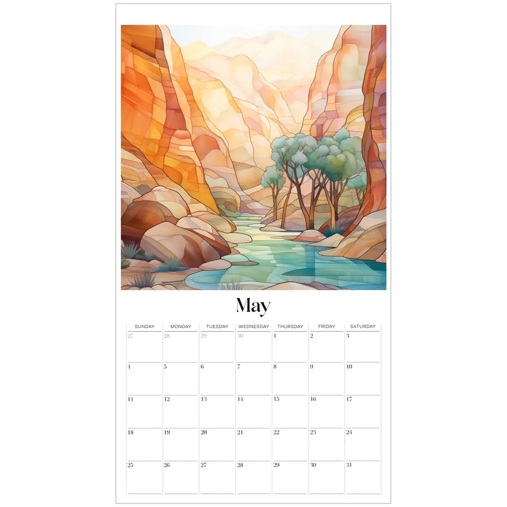 The May page of the 2025 Desert Landscapes Large Wall Calendar displays a watercolor of a serene canyon, resembling stained glass, with vibrant orange and yellow cliffs, a calm river, and trees. Dates are arranged in a grid beneath the illustration.