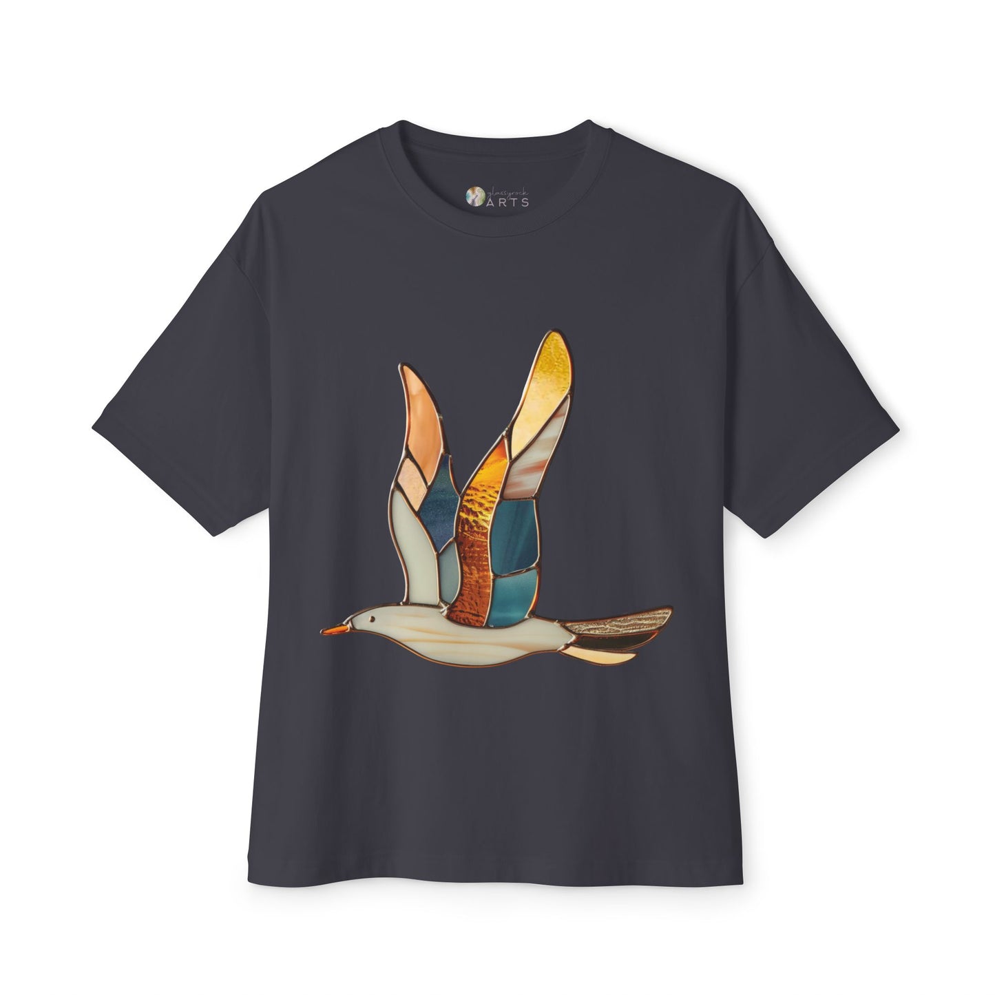 The Stained Glass Seagull Oversized Tee Shirt by Bella+Canvas is a black t-shirt adorned with a stained glass-style illustration of a flying bird with multi-colored wings, merging artistic flair with sustainable fashion.