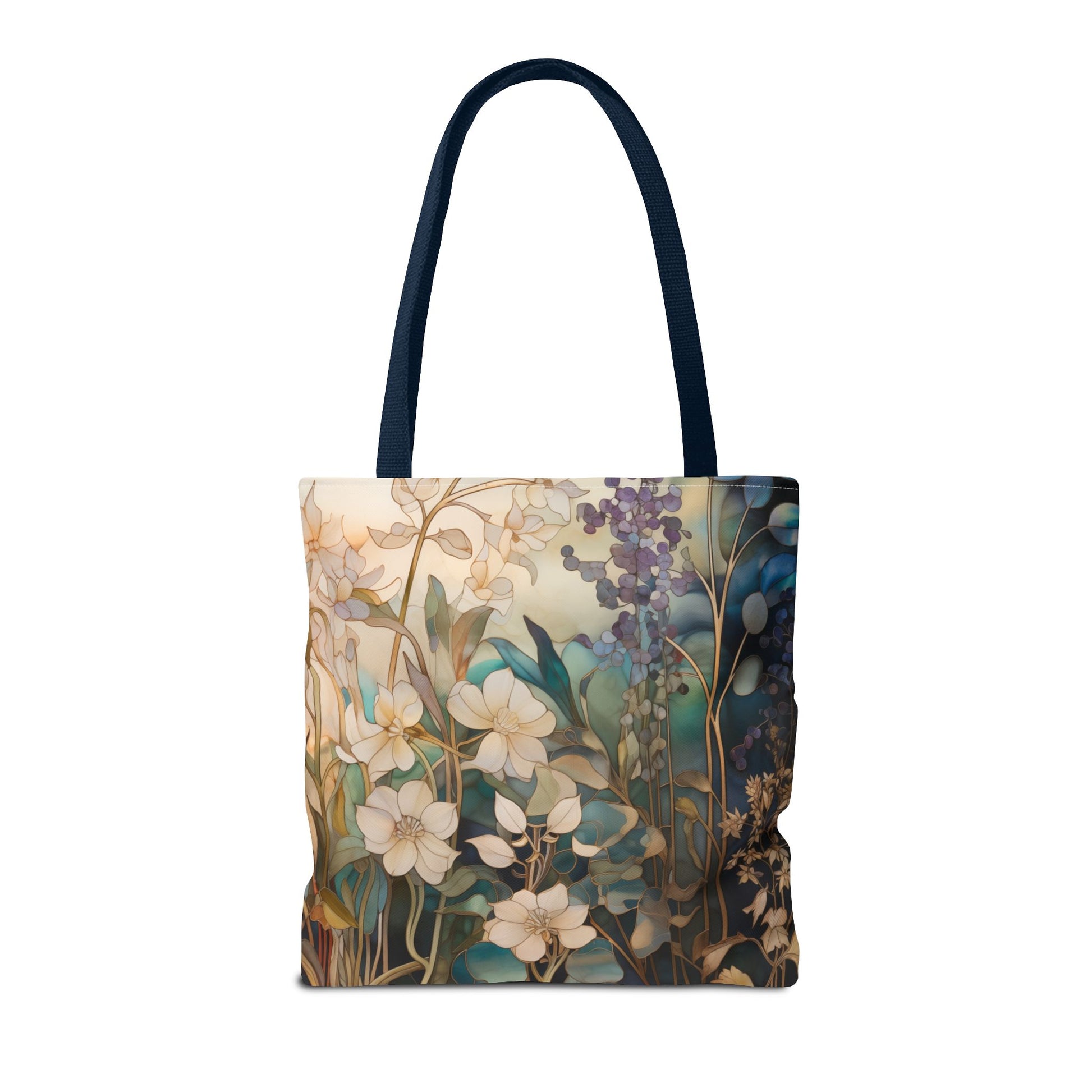 The Stained Glass Midnight Flowers Tote Bag, made from durable polyester, showcases a floral design in cream, blue, and green against a light background. It features dark handles, offering a striking contrast to the colorful pattern. Available in three sizes.