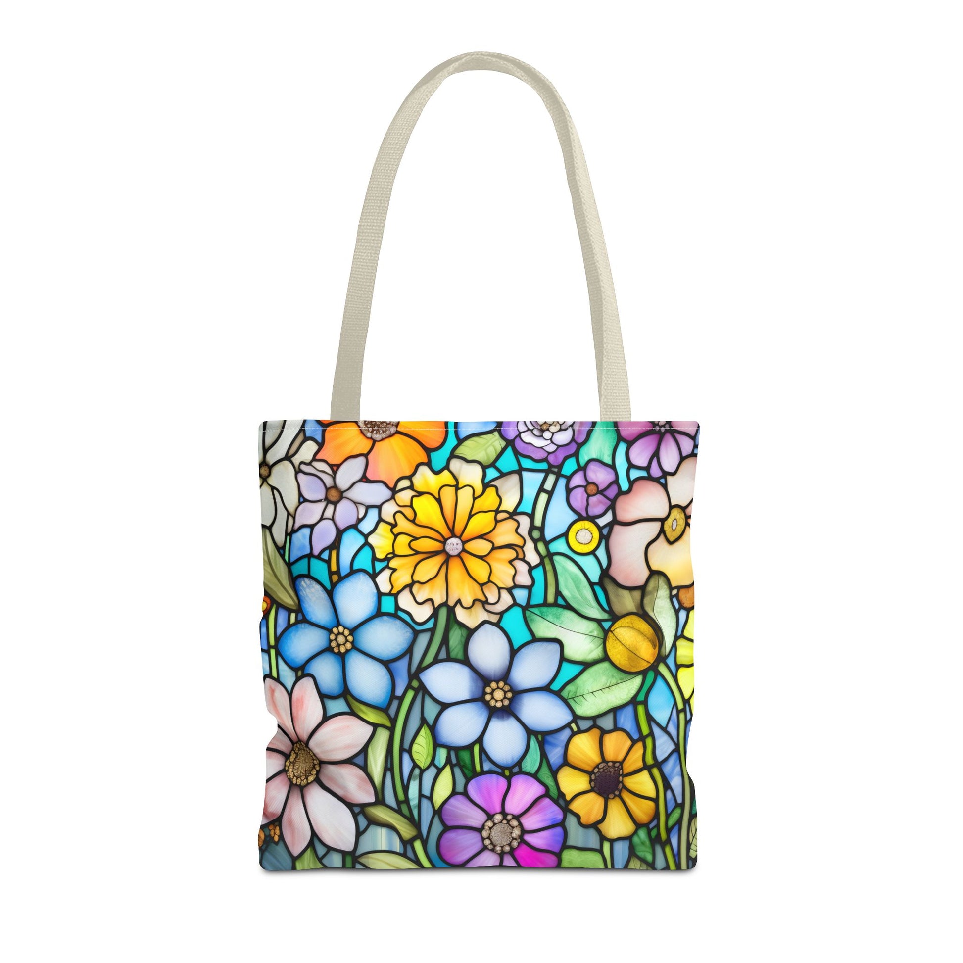 The Stained Glass Folk Art Flowers Tote Bag, available in three sizes, features an original floral design with vibrant blue, yellow, and pink flowers on a multicolored backdrop. Made from durable polyester, it has light-colored handles for comfortable carrying.