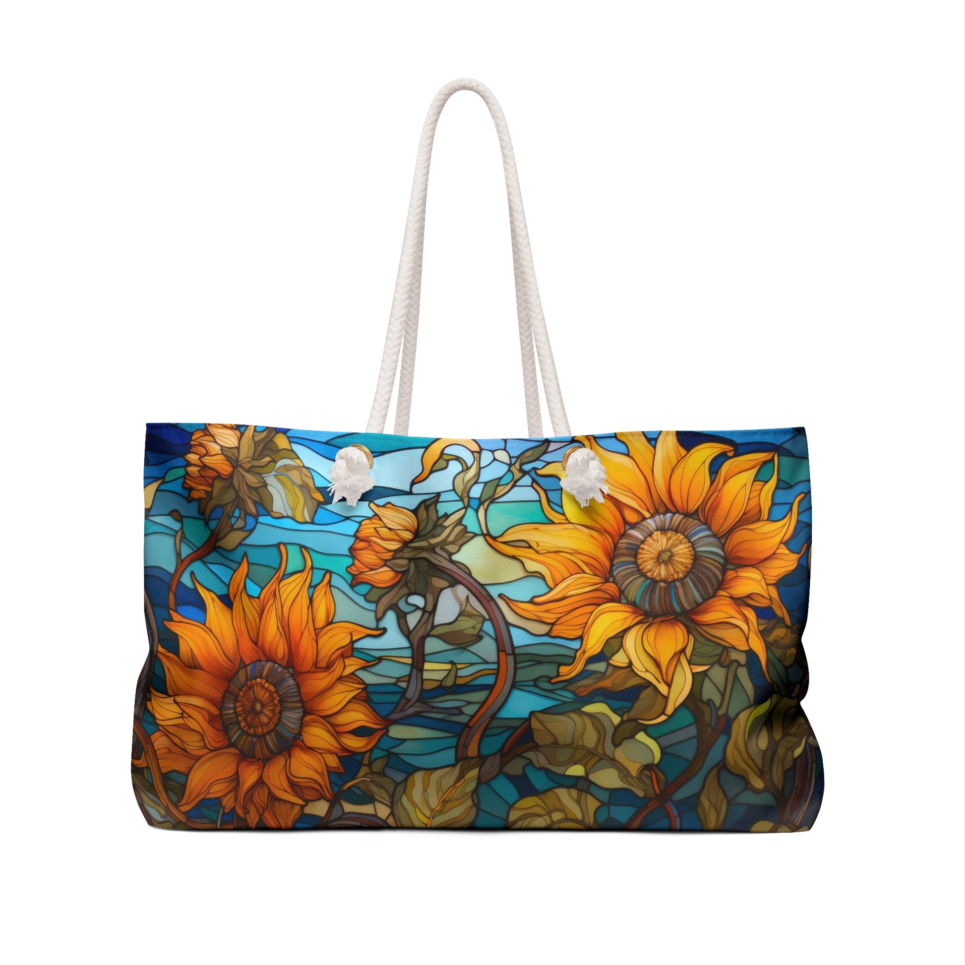 The Stained Glass Sunflowers Oversized Tote Bag in blue and yellow features a vibrant sunflower pattern with green leaves on a blue background and sturdy white rope handles for easy carrying.