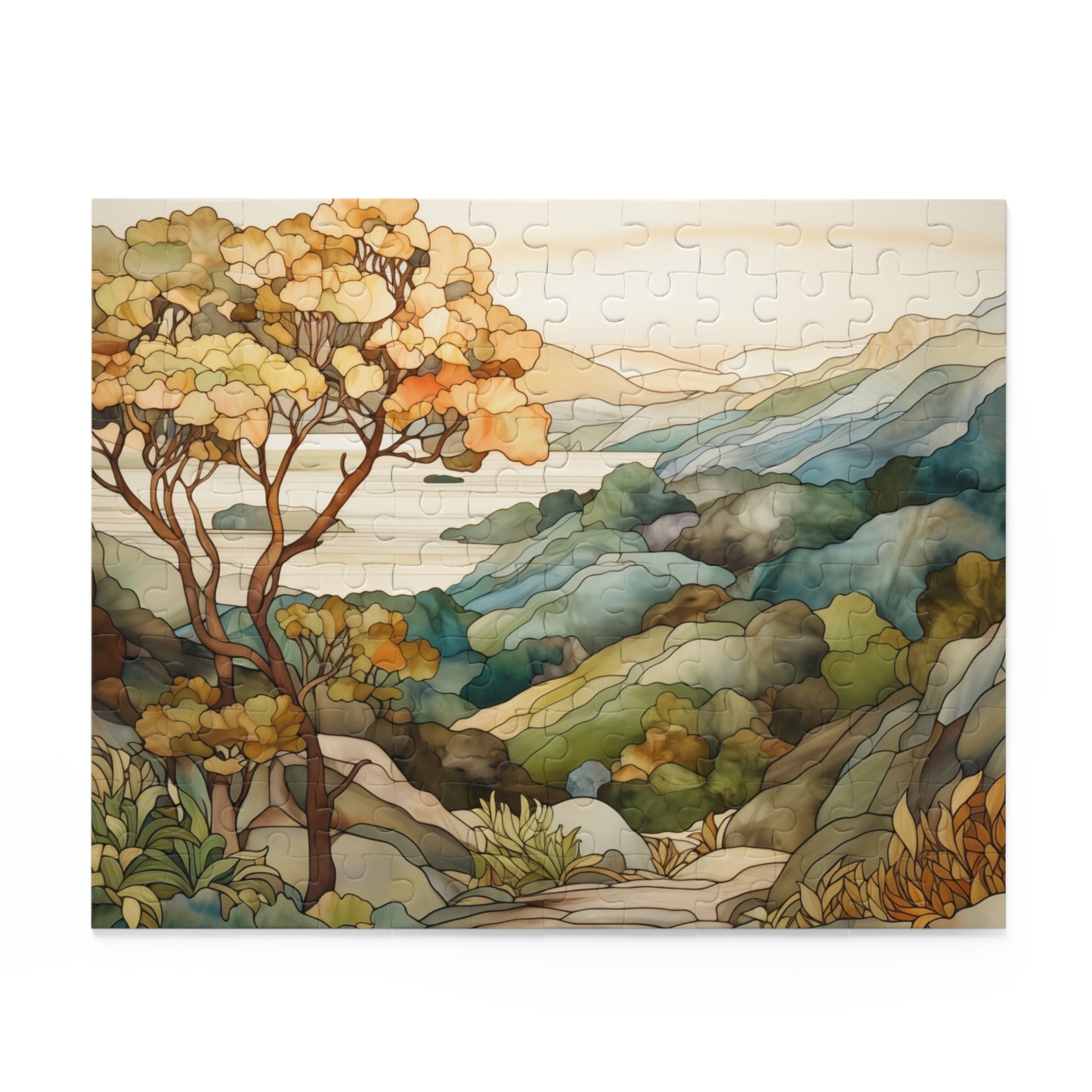 A jigsaw puzzle with a coastal scene of the Big Sur area of California, with a large tree on the left and mountains on the right and ocean in the distance. The illustration is in a stained glass style in muted colors. 