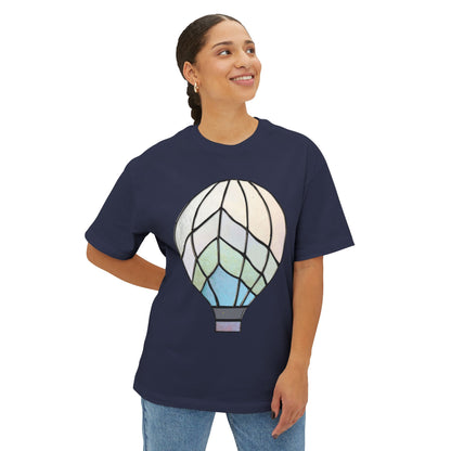 A person wearing a navy blue Stained Glass Hot Air Balloon Oversized Tee Shirt, standing with one hand on their hip and smiling.