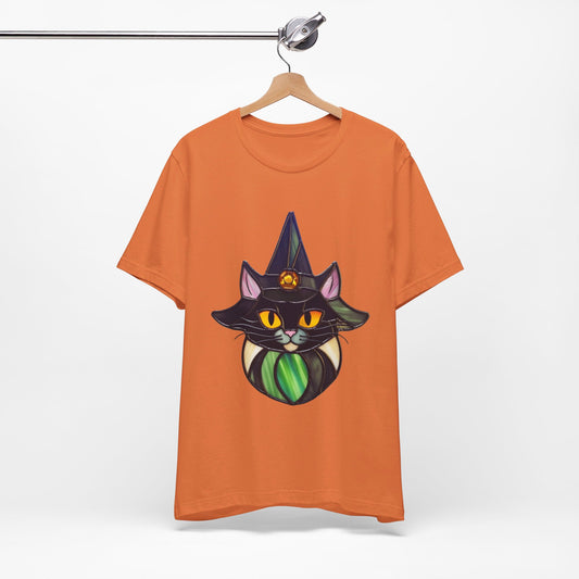 The Stained Glass Cat Witch Unisex Tee Shirt by Bella+Canvas, featuring a an adorable cat wearing a witch's hat design made of stained glass, on a unisex t-shirt.