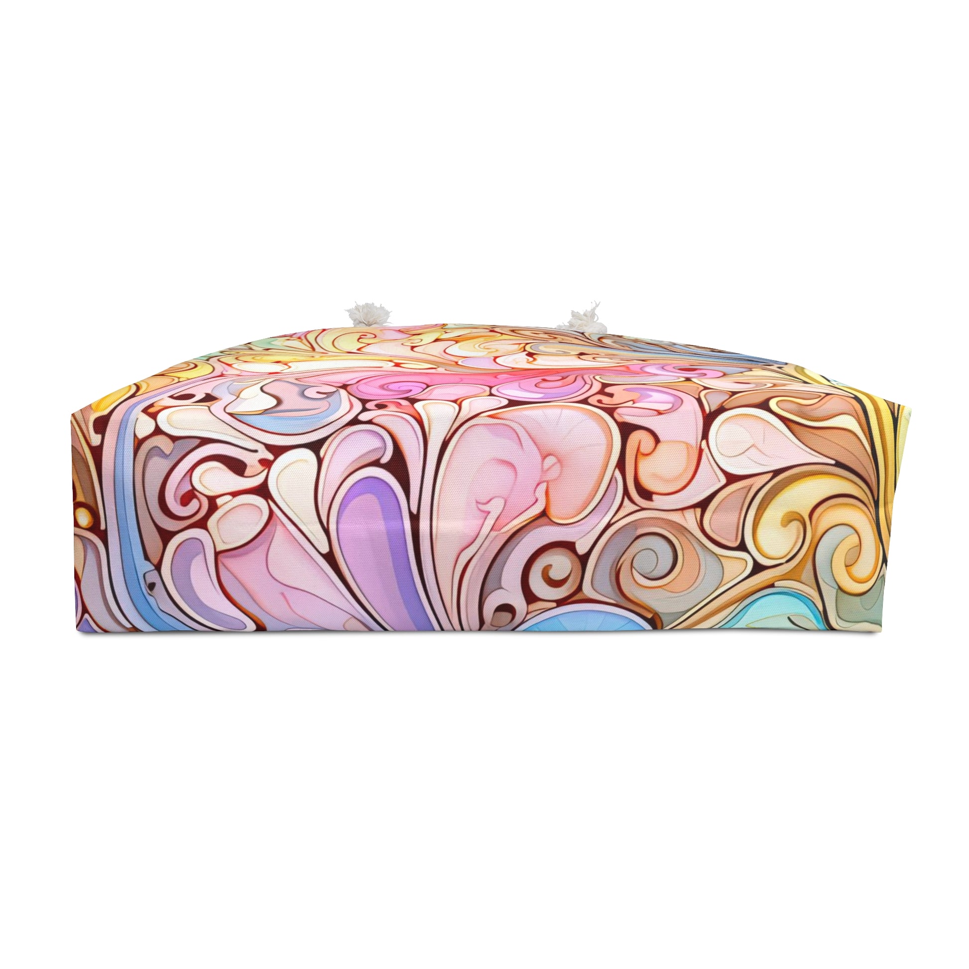 The Rainbow Paisley Stained Glass Oversized Tote Bag boasts bohemian-style swirling patterns in pink, purple, blue, yellow, and brown with elegant abstract shapes. It features small white handles on the sides.