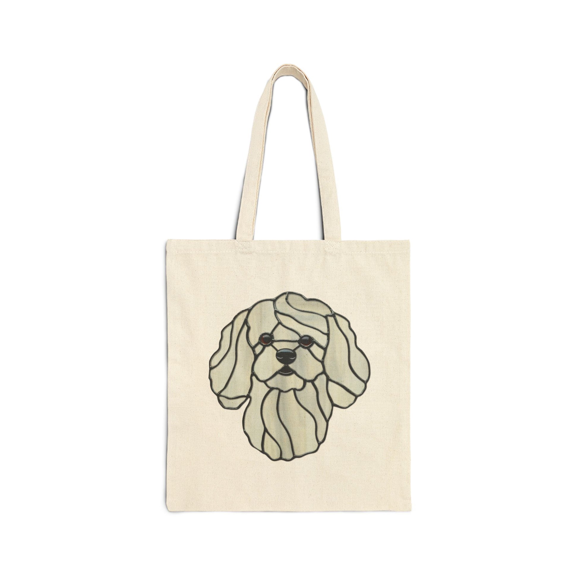 The Stained Glass Bichon Frise Cotton Canvas Tote Bag features a stylized image of a long-haired dog in black outlines on the front. Crafted from durable cotton canvas, the beige tote bag has two handles for carrying.