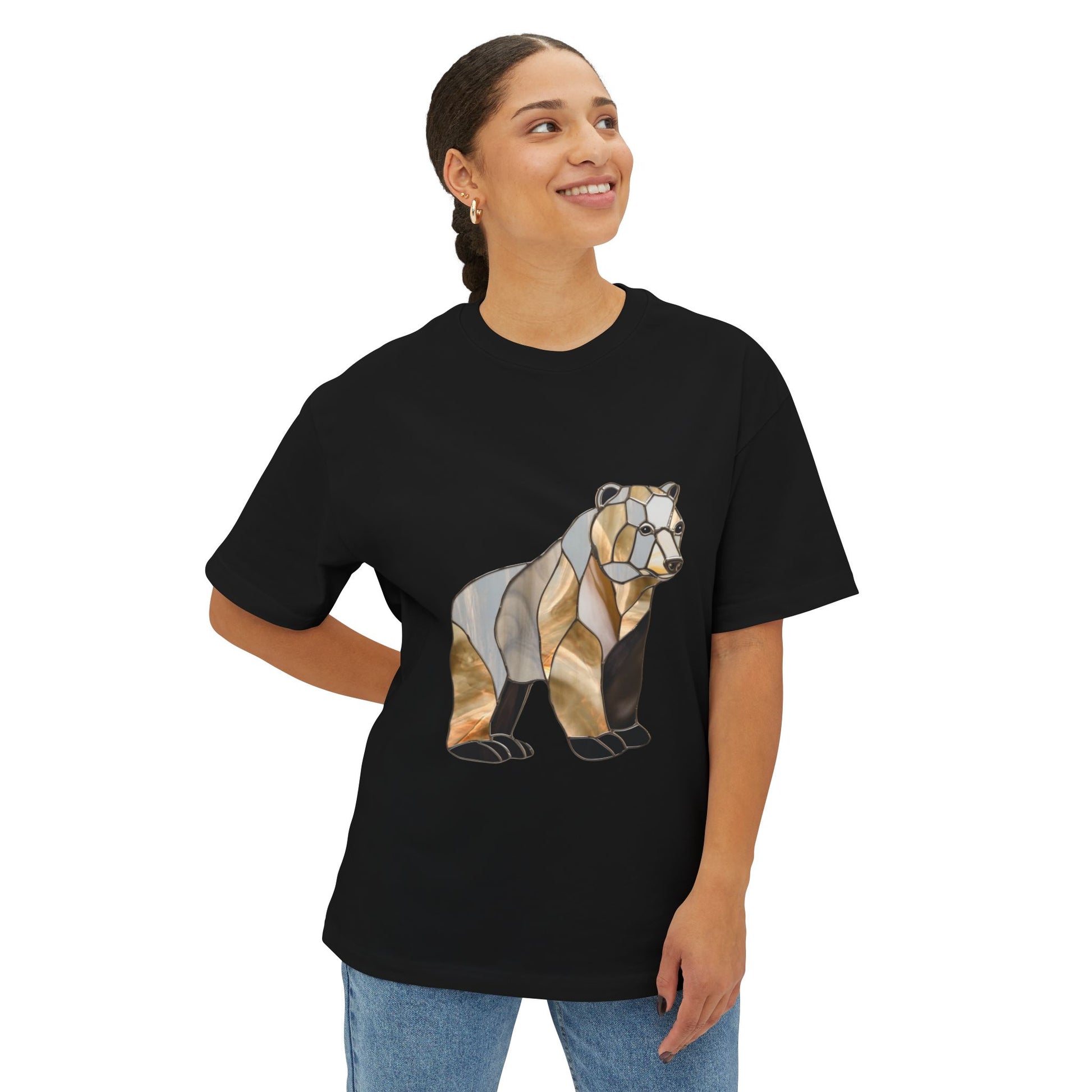 A person stands smiling, wearing the Stained Glass Grizzly Bear Oversized Tee Shirt, proudly supporting sustainable clothing.