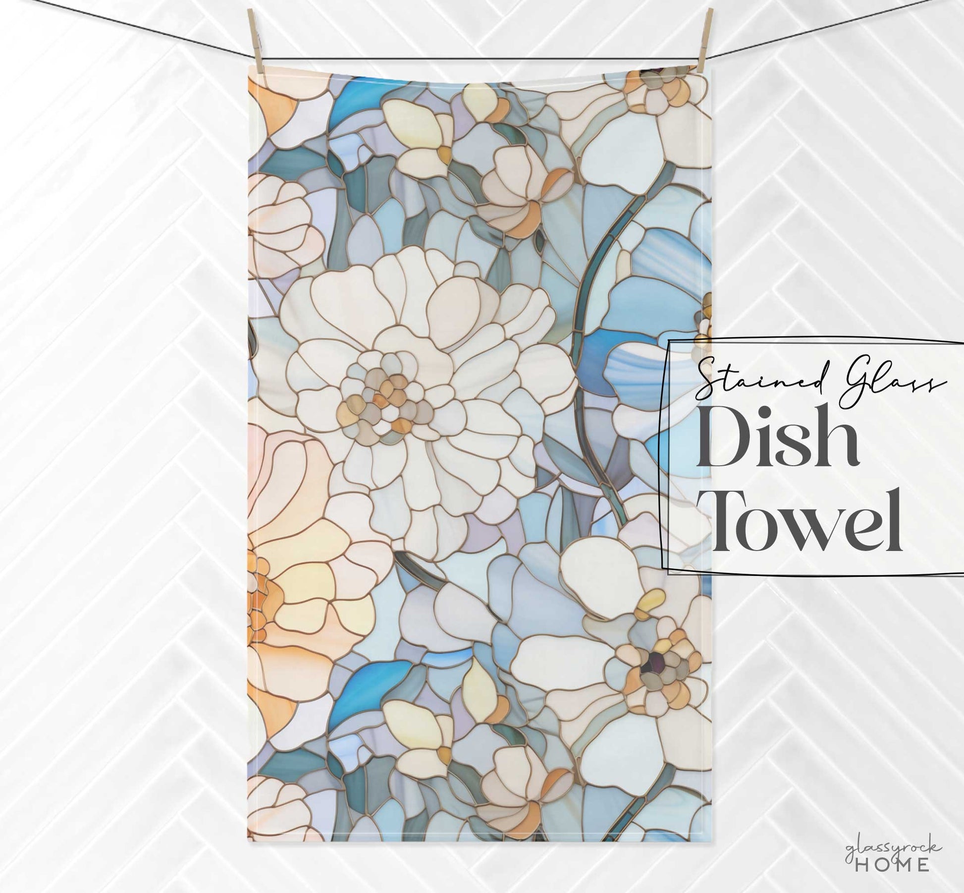 A dish towel with a stained glass-style floral design in shades of blue, white, and tan, hanging against a white tiled background. Text reads "Stained Glass Flowers Kitchen Towel." Ideal for enhancing kitchen aesthetics or as a thoughtful housewarming gift.