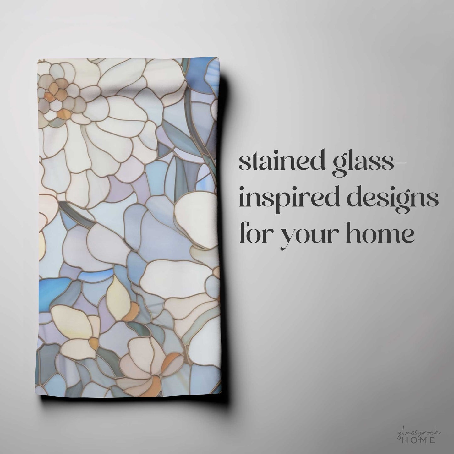 A kitchen towel named "Stained Glass Flowers Kitchen Towel" with stained glass-inspired floral designs, accompanied by text reading, "stained glass-inspired designs for your home," making it a perfect housewarming gift.