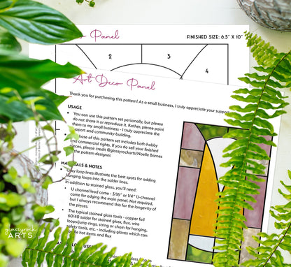 The Art Deco Stained Glass Patterns Pack includes an instruction sheet titled Art Deco Panel. It features a stunning stained glass design in yellow, pink, and brown. Available as a PDF download, the pack provides a usage guide and materials list. Displayed with green plants and a decorative bowl.