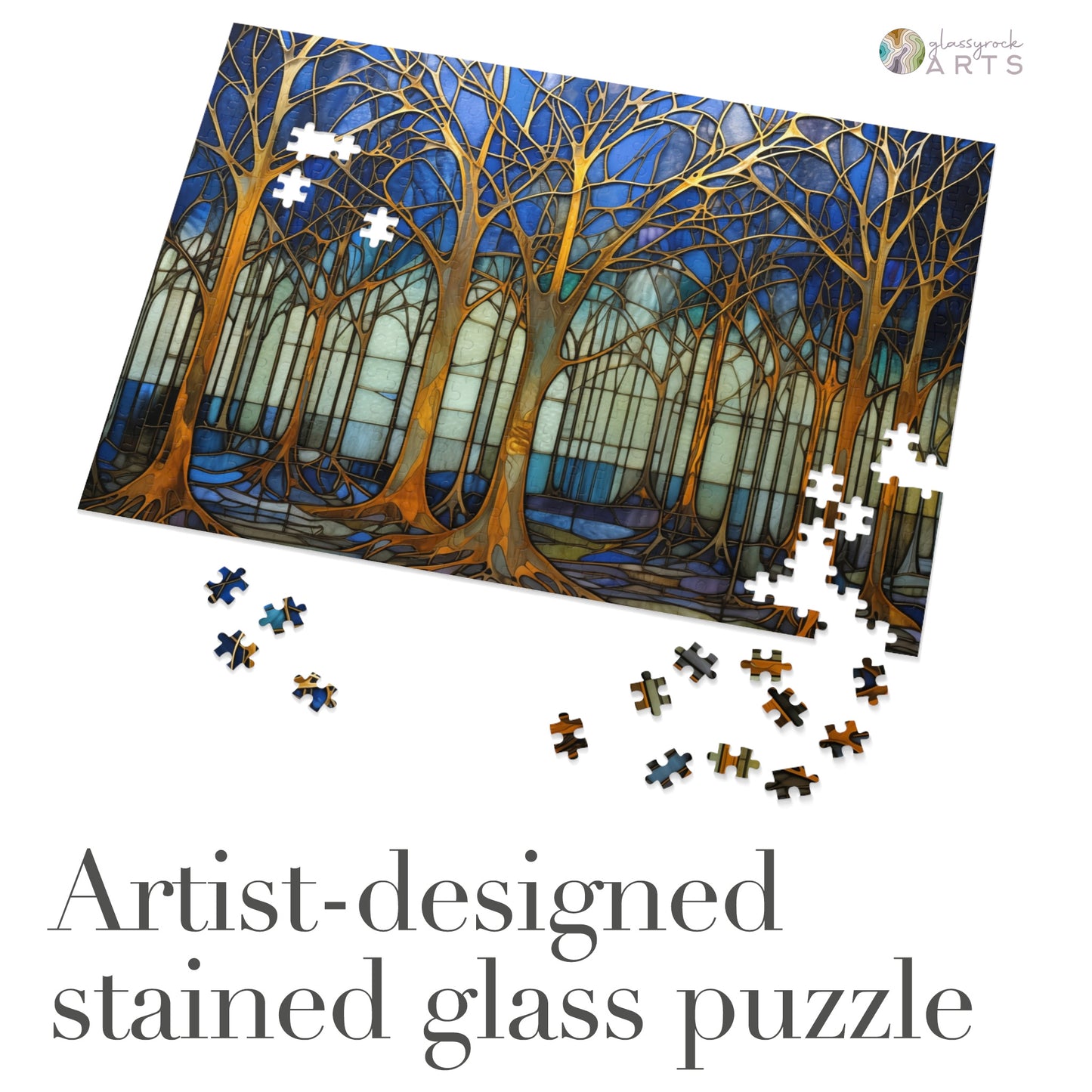 The Stained Glass Forest Jigsaw Puzzle, Blue and Gold, displays a tranquil forest scene with bare trees in blue, green, and brown tones. High-quality chipboard pieces scattered around the partially completed masterpiece make it an artist-designed gift perfect for puzzle lovers.