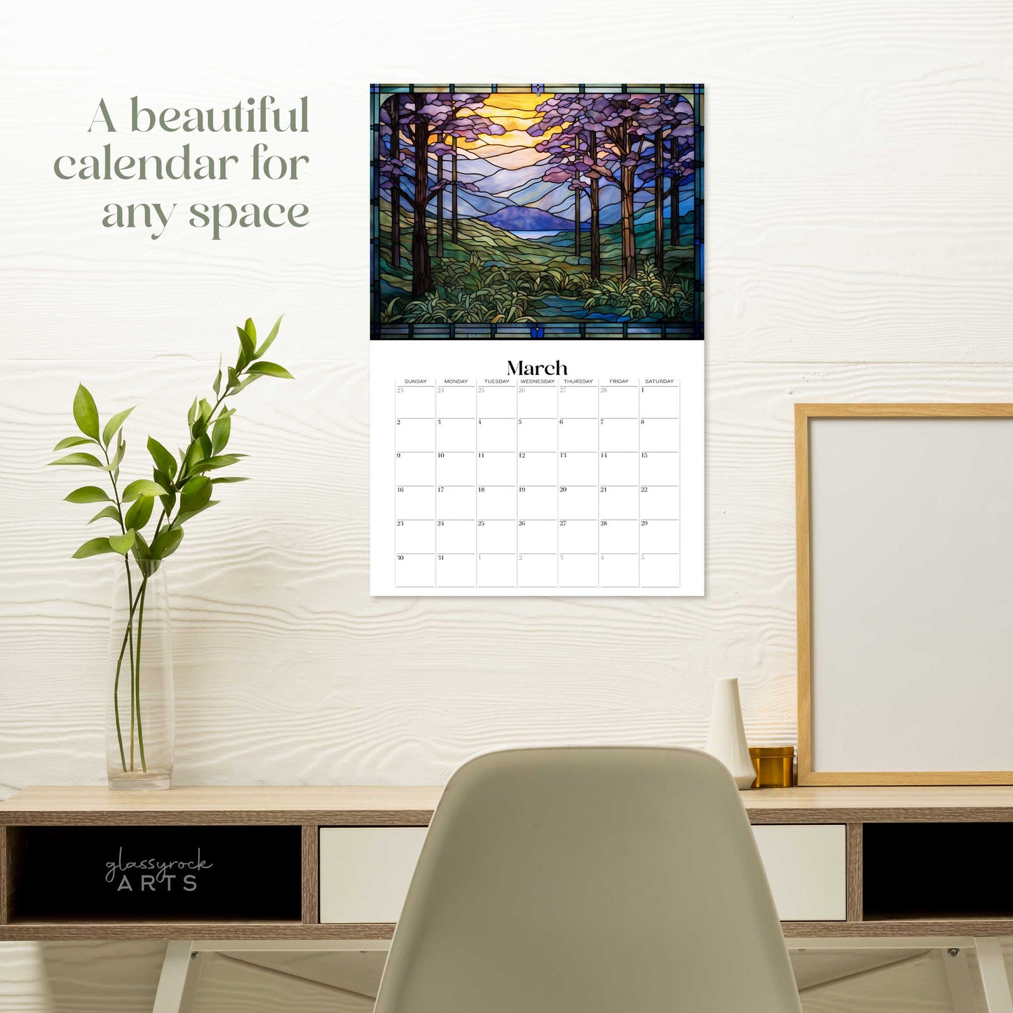 The forests calendar hanging on a white wall over a desk. The text reads "a beautiful calendar for any space."