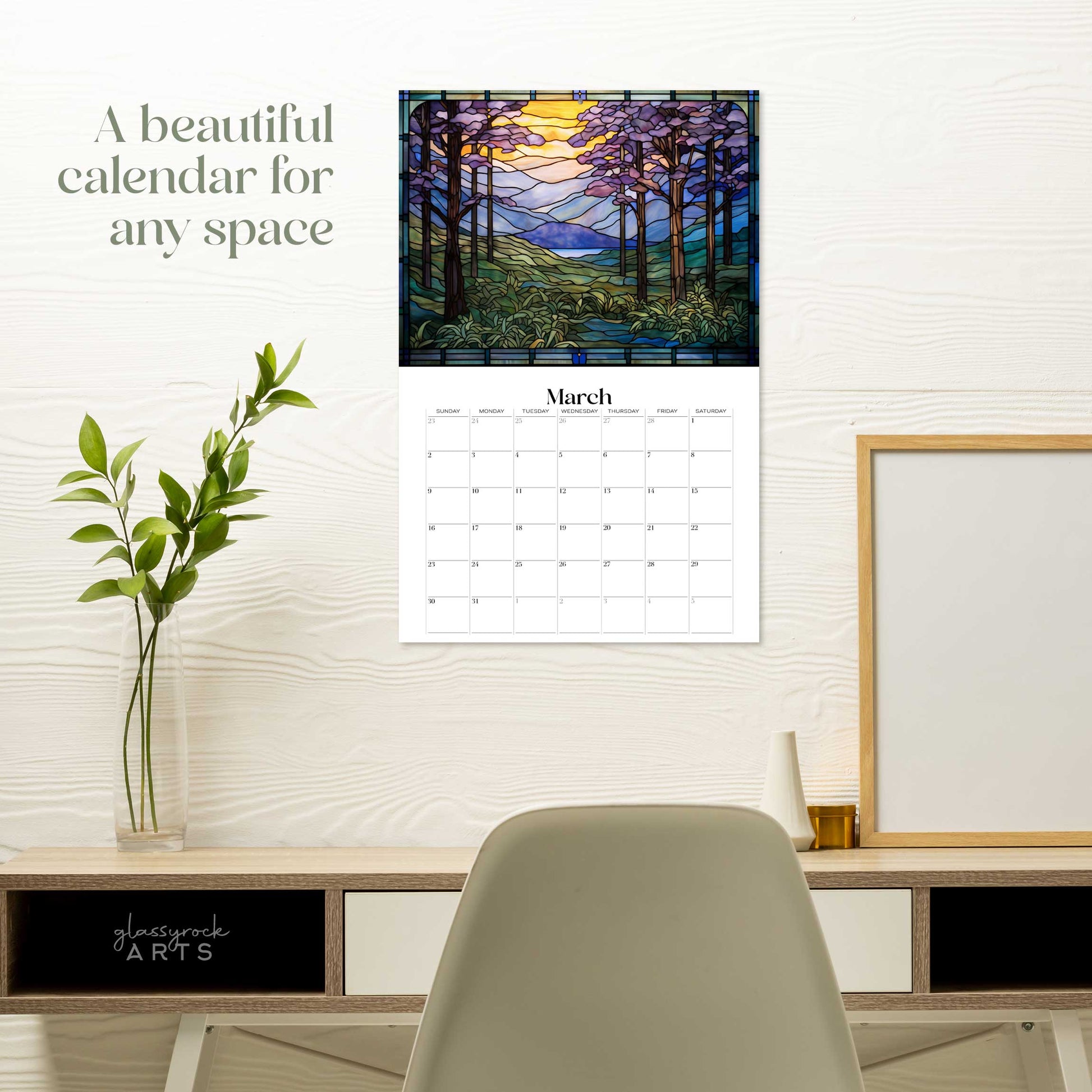 The forests calendar hanging on a white wall over a desk. The text reads "a beautiful calendar for any space."