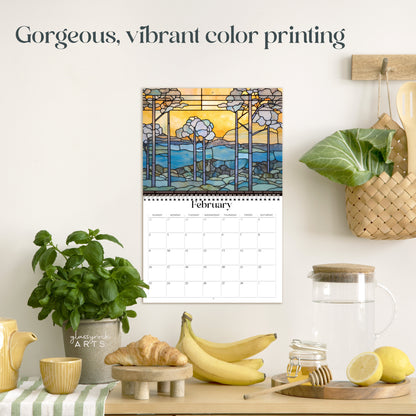 The landscapes calendar hanging in a kitchen with kitchen tools below on a counter. It has gorgeous, vibrant color printing on premium paper.