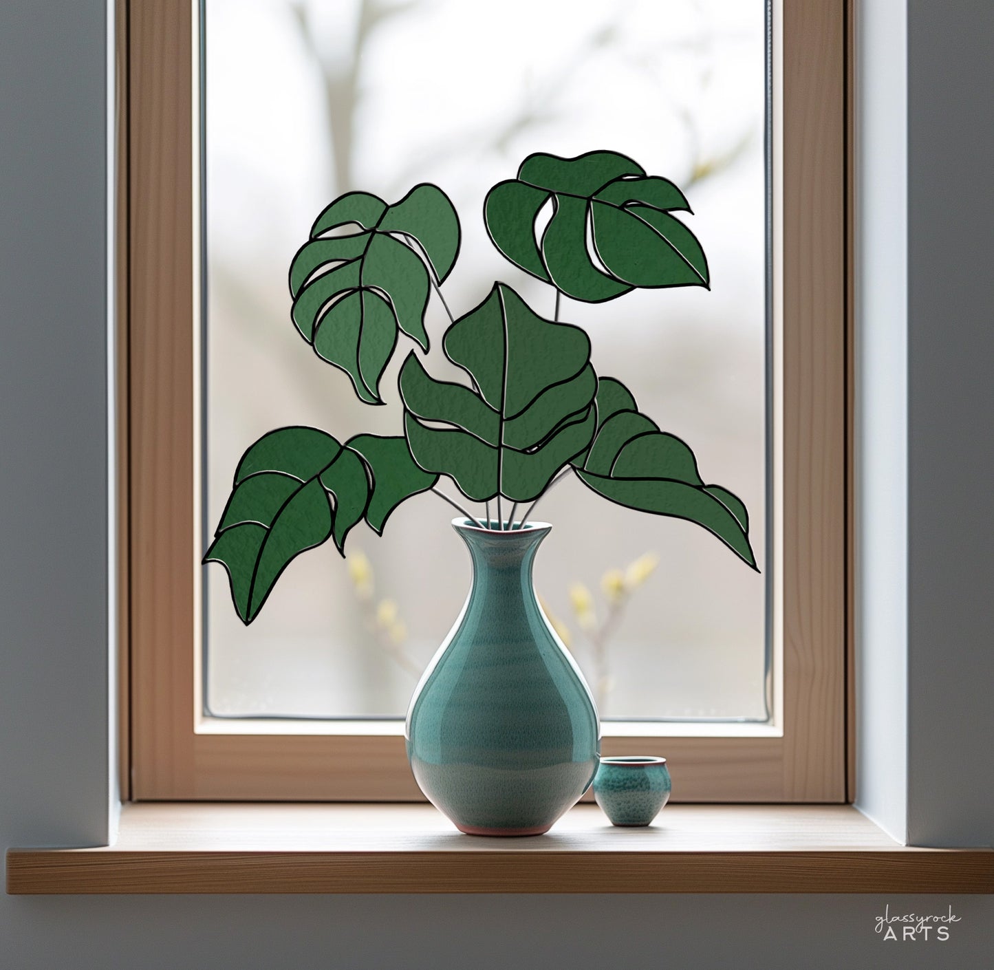 A picture of five monstera leaves in a stained glass pattern from GlassyRock Arts.