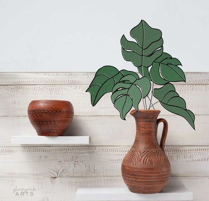 A picture of five monstera leaves in a stained glass pattern from GlassyRock Arts.